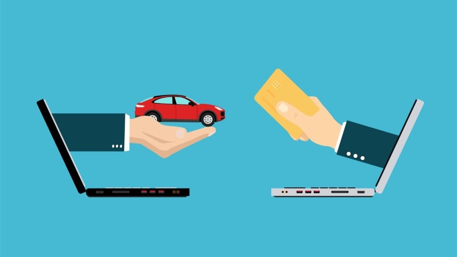 Two hands from laptops exchange a car for money