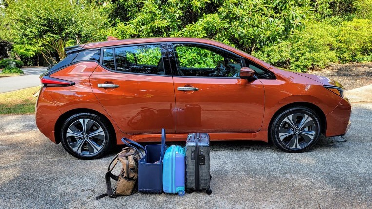 How to Take an EV Road Trip 1 Luggage next to a Nissan Leaf