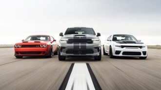 A group of Dodge vehicles drive toward the camera. We see the 2022 Dodge Challenger, Durango, and Charger from a head-on angle.