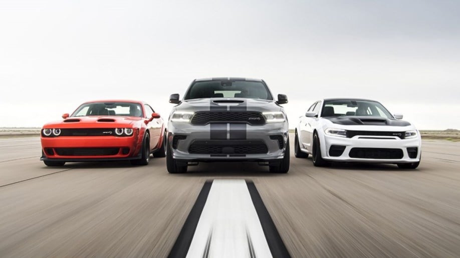 A group of Dodge vehicles drive toward the camera. We see the 2022 Dodge Challenger, Durango, and Charger from a head-on angle.