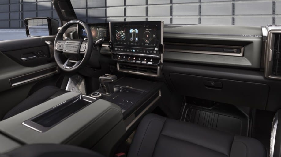 The interior of the 2022 GMC Hummer EV. It is upholstered in black leather with a huge central touchscreen. GM has said it may add up to 50 value-added, downloadable products to its cars.