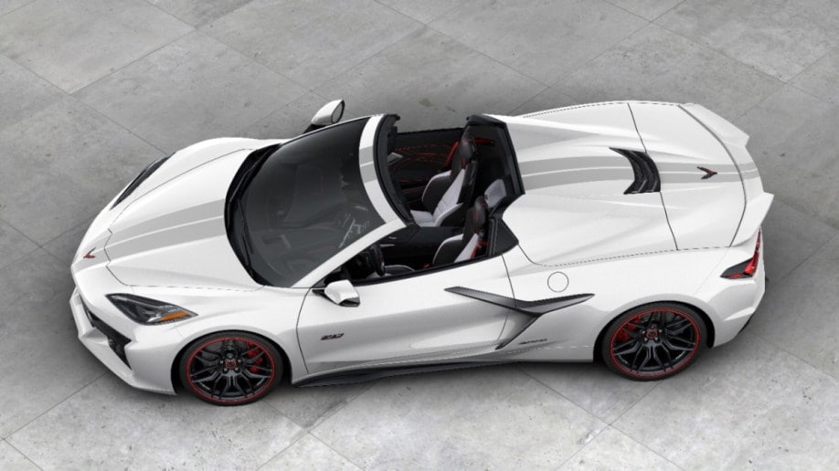 The 2023 Corvette Z06 70th anniversary edition convertible sits parked on Concrete. The car is white, with gray stripes. We see it from an overhead angle.
