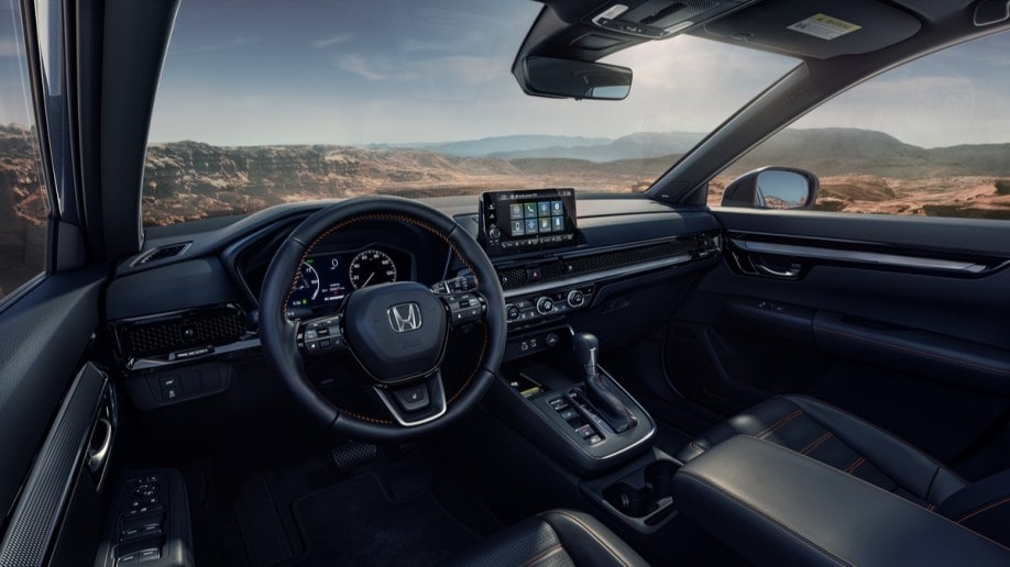 The cabin of the 2023 Honda CR-V. It is upholstered in black leather, with a 9-inch touchscreen standing out from the dashboard.