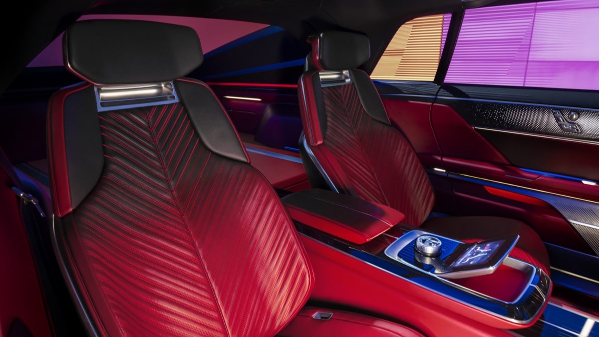 The interior of the Cadillac Celestic show car. We see the rear seats, upholstered in a leather chevron pattern that is red at the bottom and black at the top.