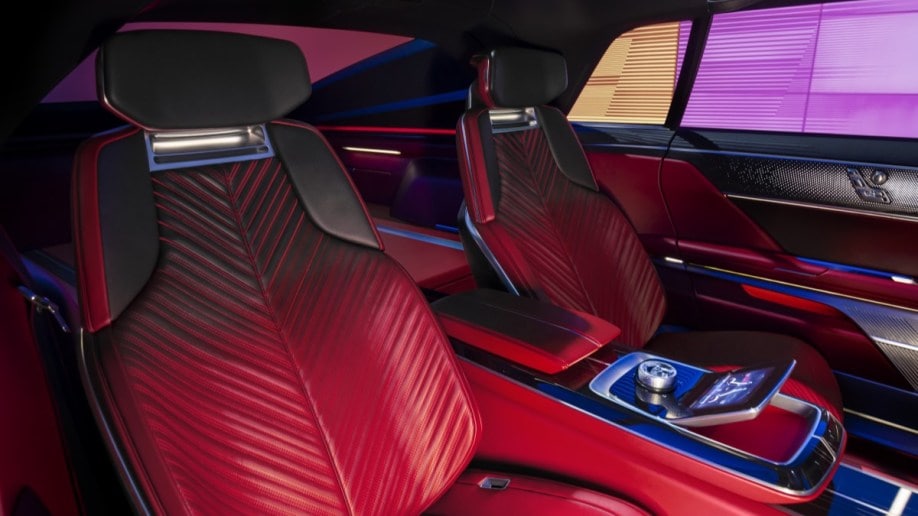 The interior of the Cadillac Celestic show car. We see the rear seats, upholstered in a leather chevron pattern that is red at the bottom and black at the top.