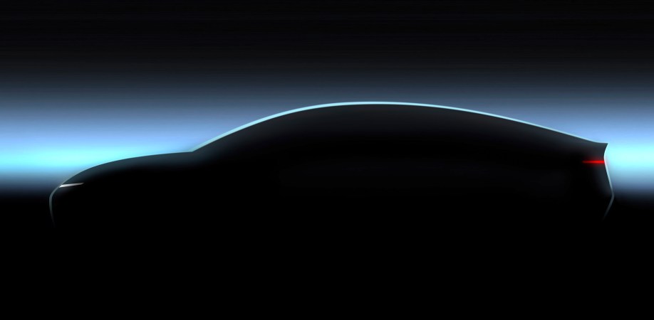 A teaser image Volkswagen released showing its Trinity concept car. We see just the profile of the car in shadow. It is a fastback design with a long, curved roof.