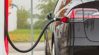 A Tesla connected to a charging cable