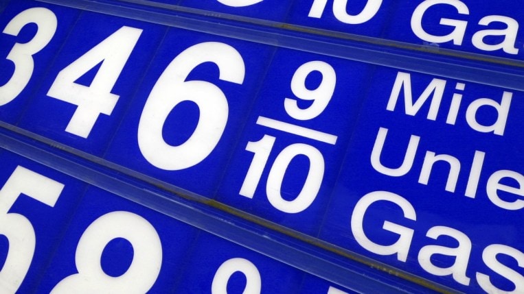 A closeup photograph of a gas price sign, showing a price of $3.47 for mid-grade unleaded gasoline.