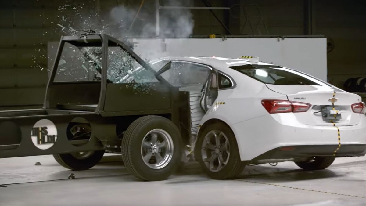 The 2022 Chevy Malibu undergoes side-impact crash testing at an Insurance Institute for Highway Safety laboratory. We see the test sled crashing into the side of the Malibu, which earned a score of "Poor.""