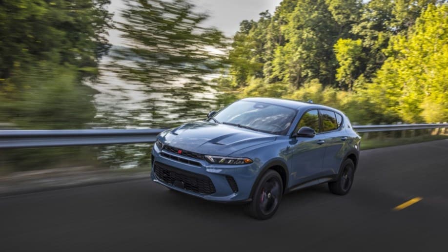 The 2023 Dodge Hornet seen from a front quarter angle. The SUV is a chalky light blue. We see it facing slightly to our left.