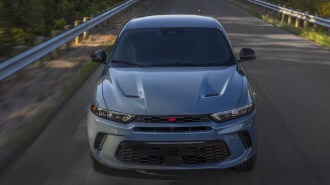 The 2023 Dodge Hornet seen from head-on. The SUV is a chalky shade of blue, with vents and deep character lines in its hood.