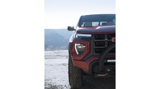 A teaser photo shows just half of the grille of the 2023 GMC Canyon midsize truck