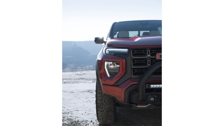 A teaser photo shows just half of the grille of the 2023 GMC Canyon midsize truck