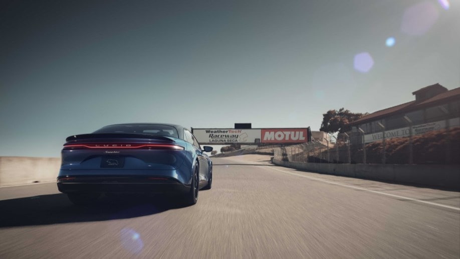 The Lucid Air Sapphire laps the race course at Laguna Seca. We see it from the rear.