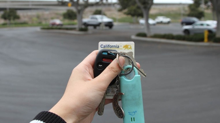 Hand holding keys and a Real ID