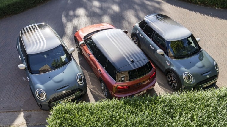 The three Mini Multitone Editions -- Sage Green 3-door, Indian Summer Red Clubman wagon, and Sage Green 5-door