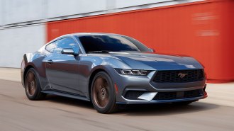 2024 Ford Mustang driving on a racetrack.