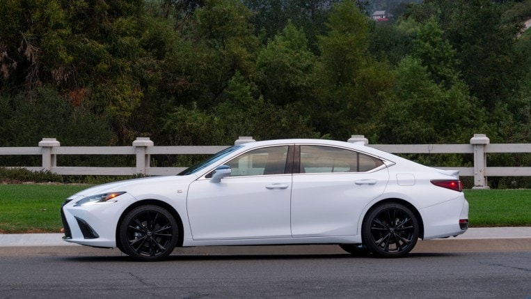 White 2023 Lexus ES 300h parked near fence