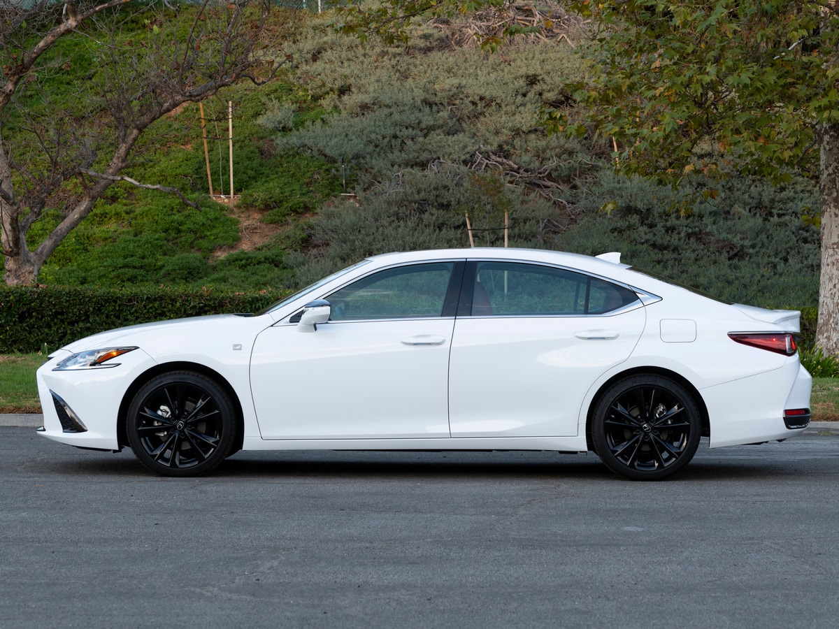 White 2023 Lexus ES 300h parked near hill