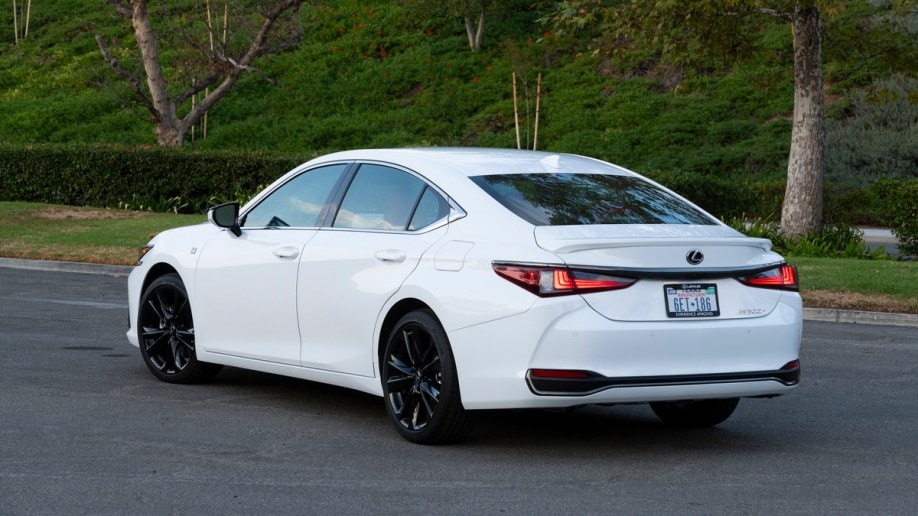 White 2023 Lexus ES 300h parked near trees