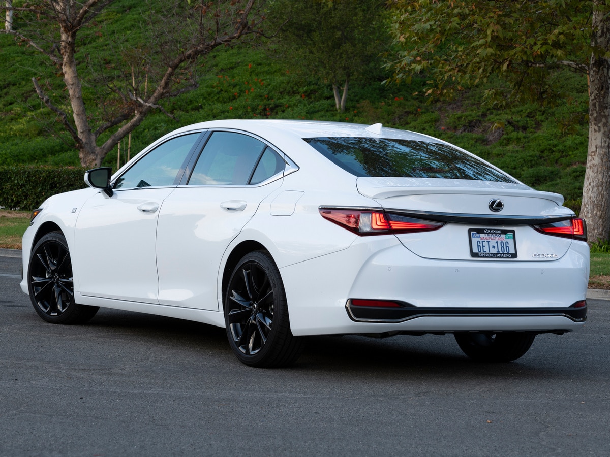 White 2023 Lexus ES 300h parked near trees