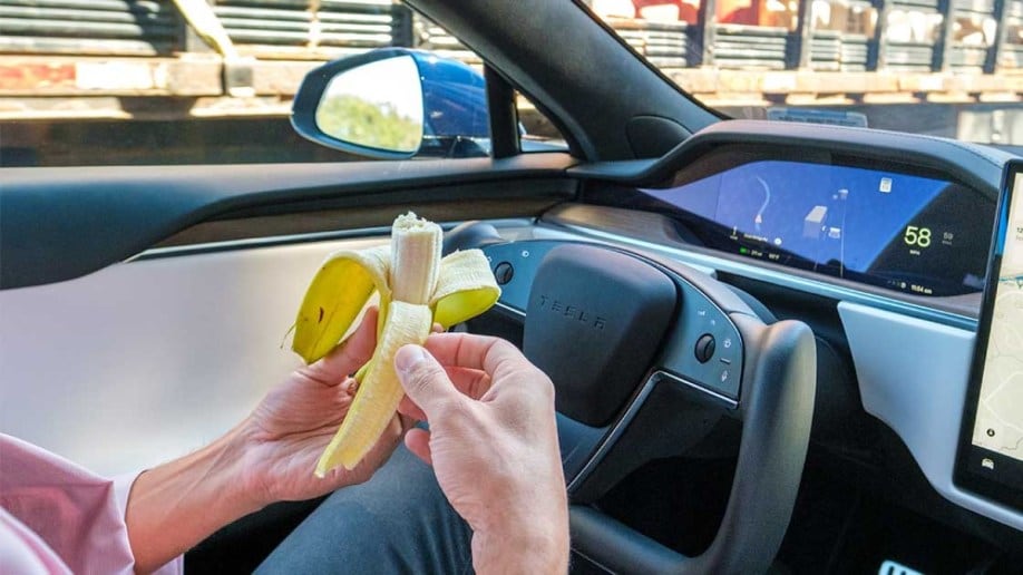 A driver eats a banana in a Tesla - photo courtesy of the Insurance Institute for Highway Safety