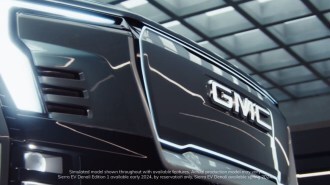 A teaser image shows the grille of the upcoming electric GMC Sierra