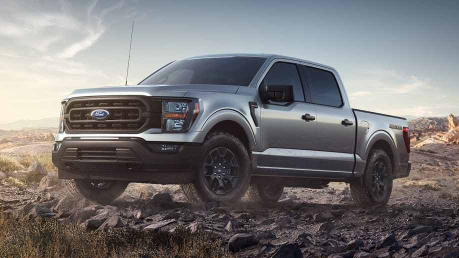 Silver 2023 Ford F-150 Rattler driving on rocky terrain
