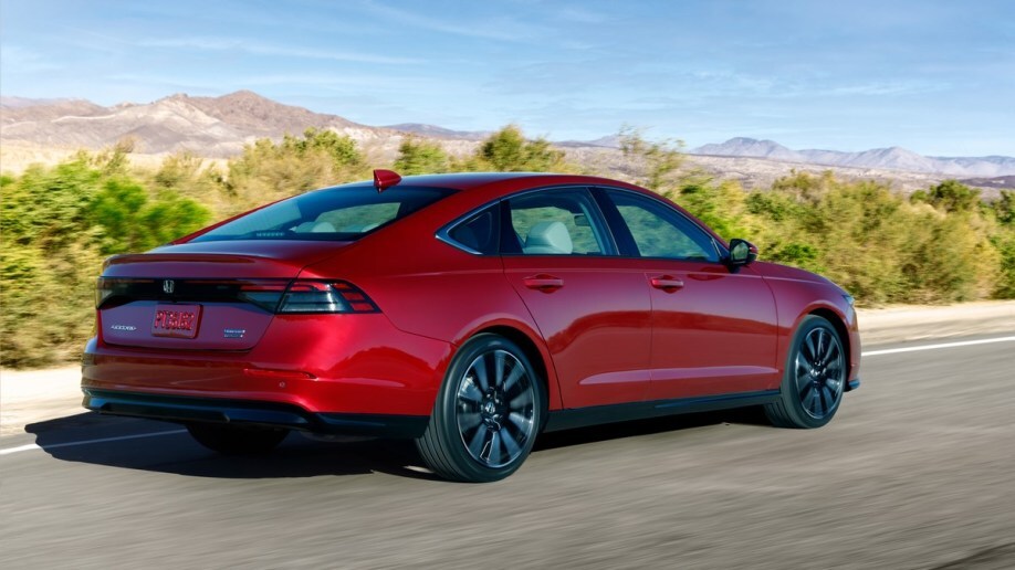 The 2023 Honda Accord in red, seen from a rear quarter angle