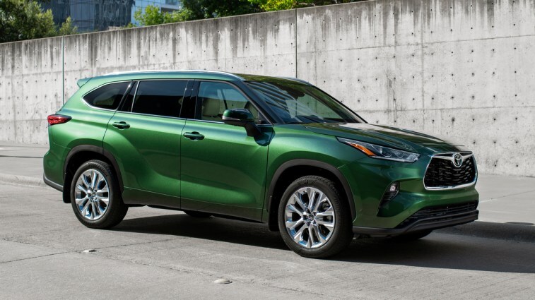 Green 2023 Toyota Highlander near concrete wall