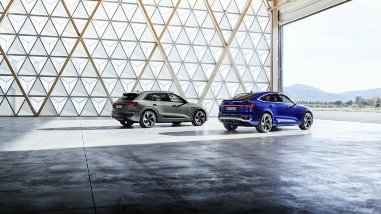 The 2024 Audi Q8 e-tron in grey, and Q8 e-tron Sportback, in blue, from a rear quarter angle