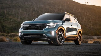 Blue 2024 Kia Seltos near forest