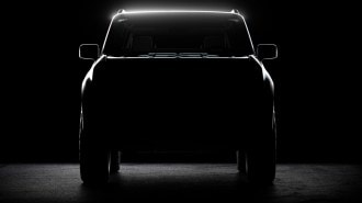 A teaser shot shows a head-on view of the first Scout EV prototype