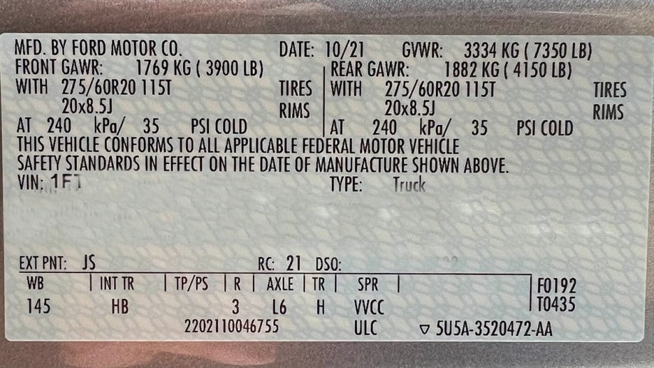 The sticker from a Ford F-150 door jamb showing towing specifications