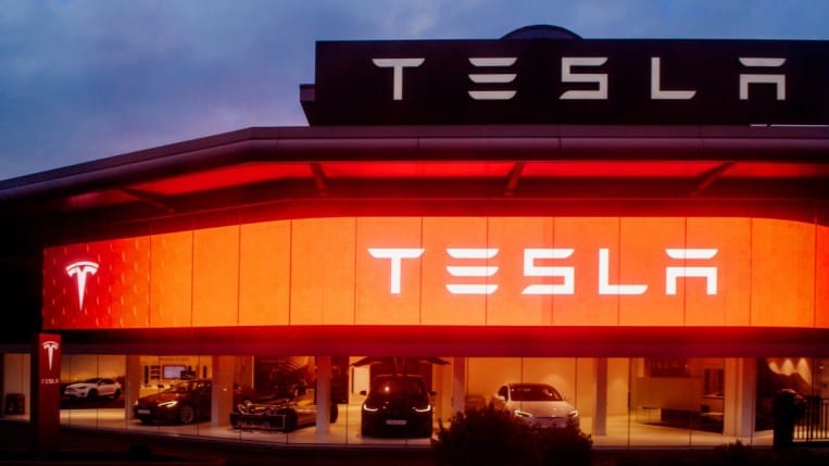 A Tesla dealership lit up at night