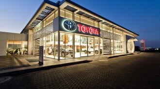 A Toyota dealership lit up at dusk
