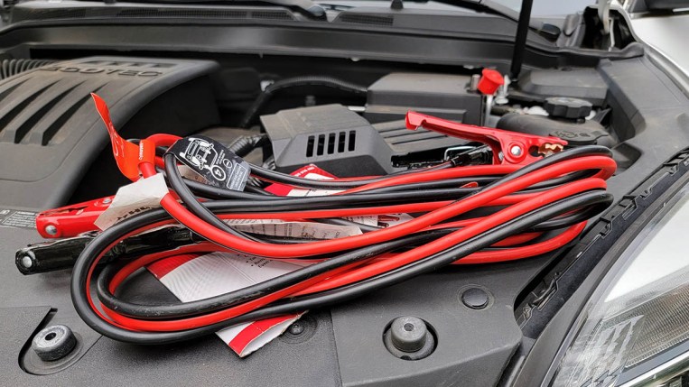 Jumper cables next to engine compartment