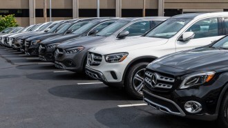 A line of Mercedes-Benz cars for sale at a dealership
