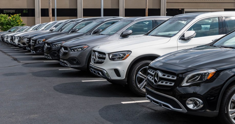 A line of Mercedes-Benz cars for sale at a dealership