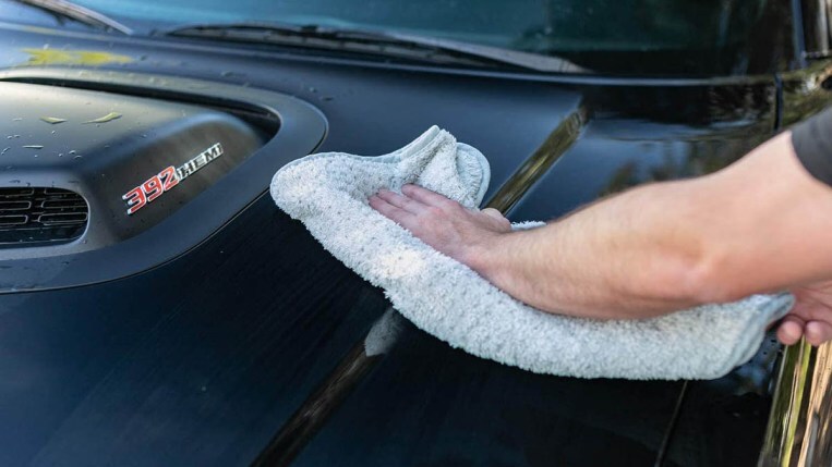 Platinum Pluffle towel drying a car hood.