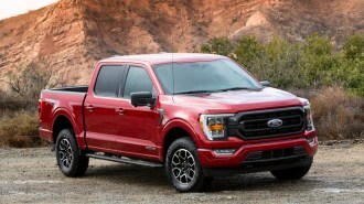 Red 2021 Ford F-150 Hybrid near hill