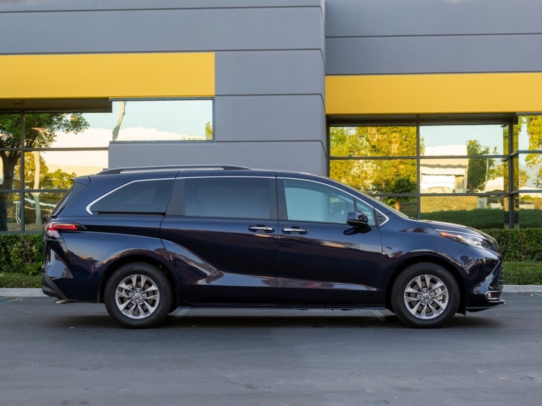 Blue 2022 Toyota Sienna near building.