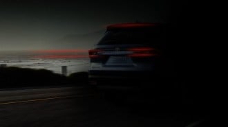 A teaser photo showing the rear of the 2024 Toyota Grand Highlander obscured by shadows