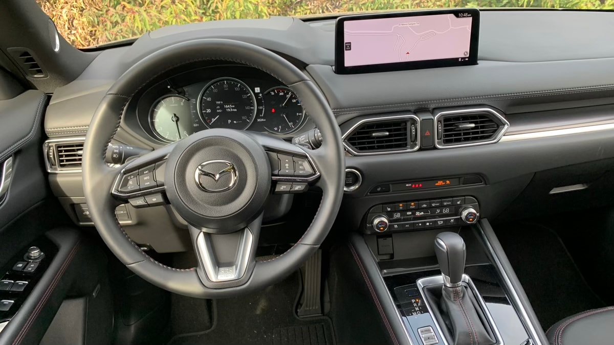 The interior of the 2023 Mazda CX-5 2.5 Turbo in black with red stitching