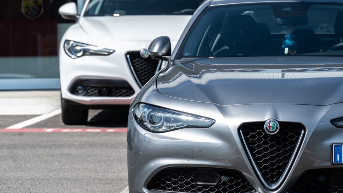 A pair of Alfa Romeo Giulia sedans parked at a dealership
