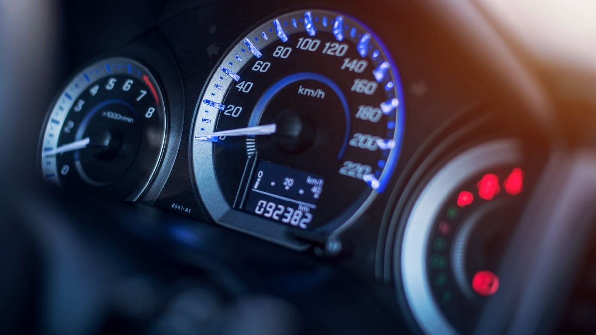 A closeup of a car's dashboard showing a digital odometer