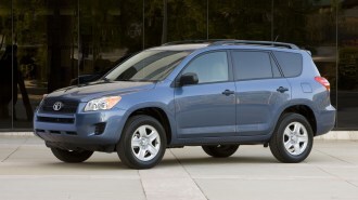 2010 Toyota RAV4 in front og office building.
