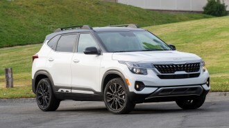 2023 Kia Seltos on an angle near grassy hill.