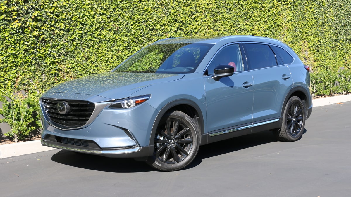 2023 Mazda CX-9 Carbon Edition near green backdrop.