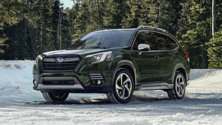 2023 Subaru Forester in green driving in snow.